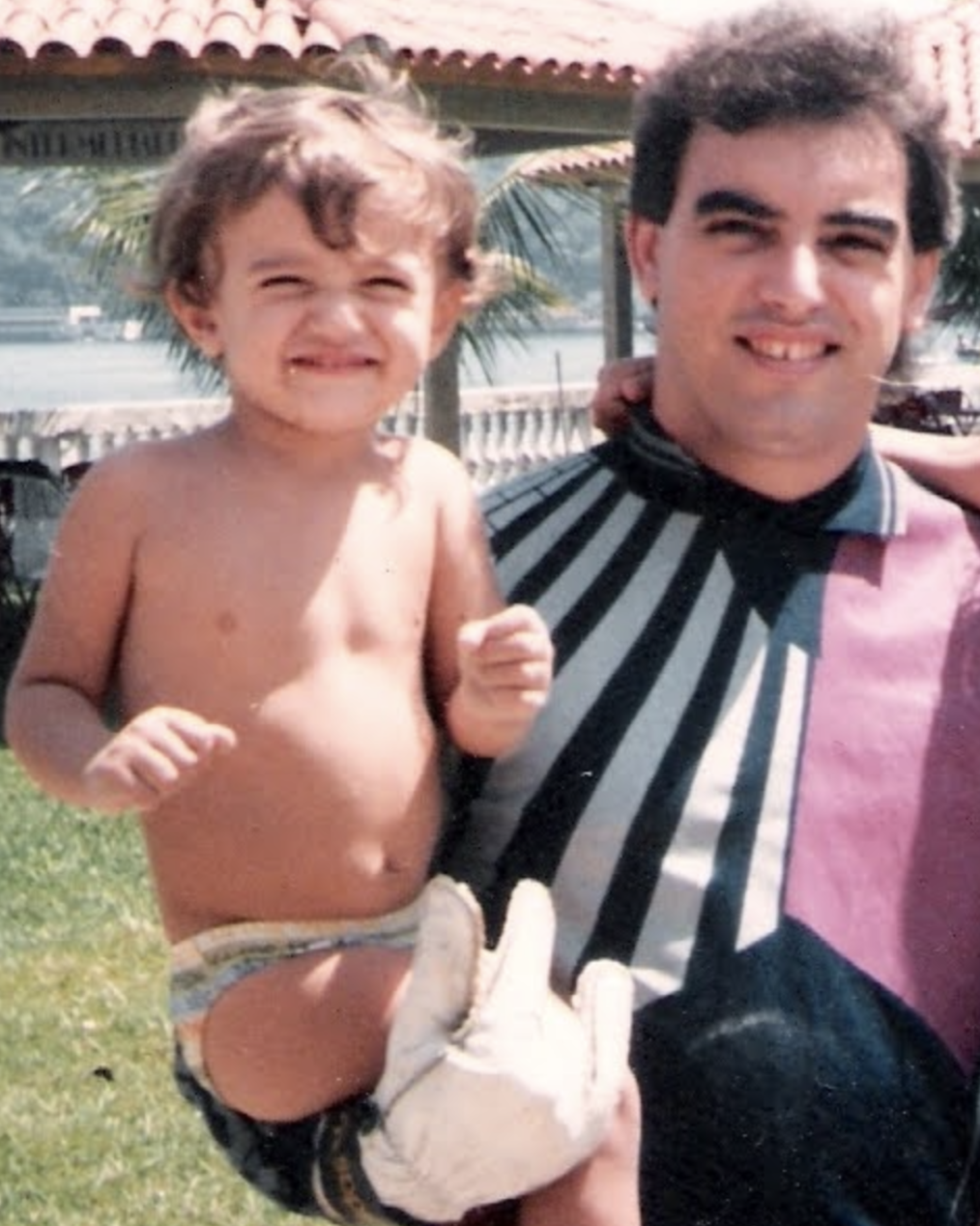 My father in his goalkeeper outfit, holding me
